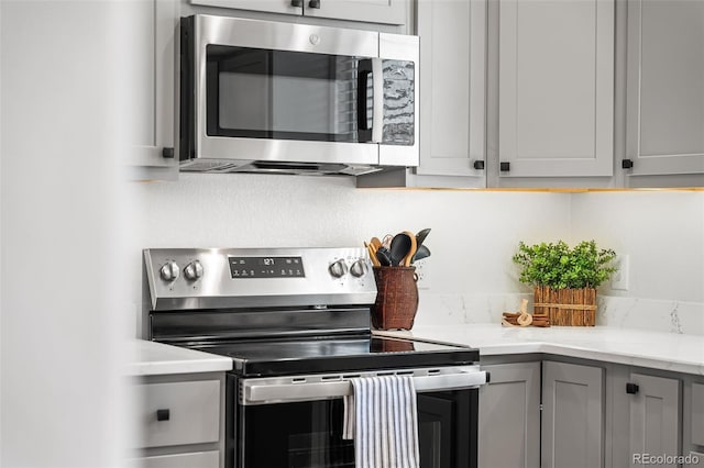 7600 W Coal Mine Ave Unit B, Littleton, CO 80123 - kitchen with appliances with stainless steel finishes and gray cabinetry