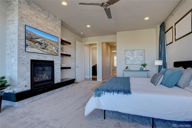 bedroom with ceiling fan and a fireplace