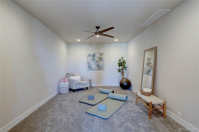 exercise room featuring ceiling fan and carpet