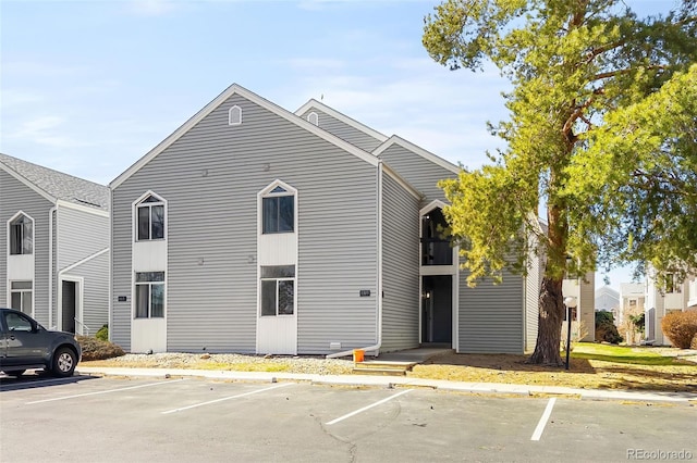 view of property featuring uncovered parking