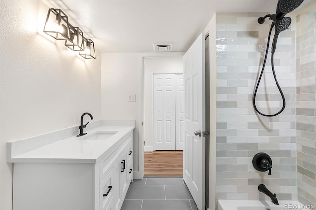 full bathroom featuring vanity, shower / bathing tub combination, visible vents, and tile patterned floors