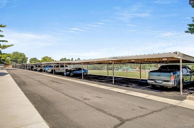 covered parking lot featuring playground community