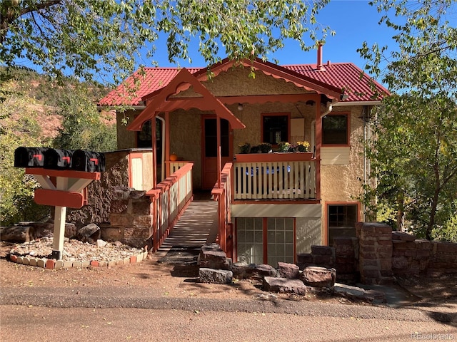 136 Cave Ave, Manitou Springs, CO 80829 - view of front of property with a tiled roof and stucco siding