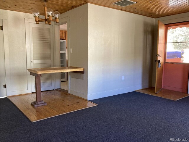 136 Cave Ave, Manitou Springs, CO 80829 - unfurnished dining area with wooden ceiling, a chandelier, and carpet
