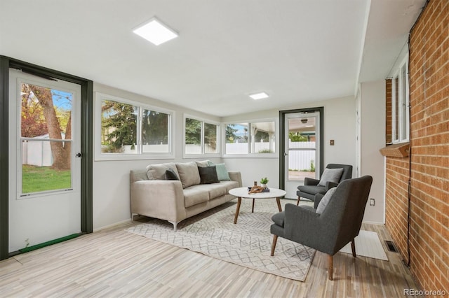 sunroom / solarium featuring vaulted ceiling