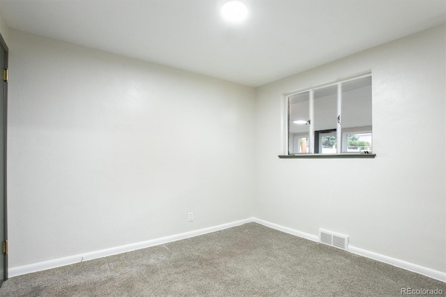 spare room with carpet floors and baseboards