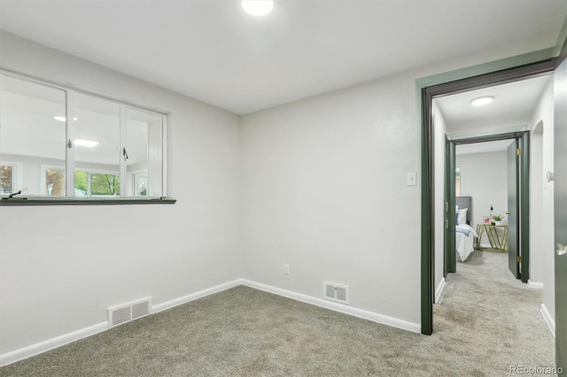 carpeted empty room with baseboards