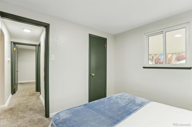 bedroom featuring carpet and baseboards