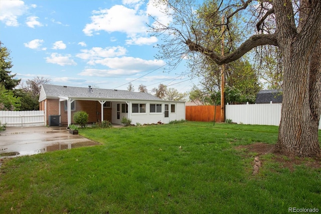 rear view of house featuring cooling unit and brick siding
