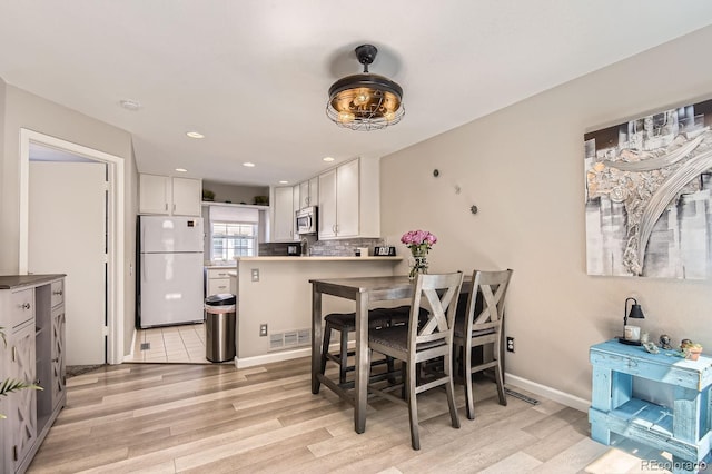 2890 W Long Cir Unit A, Littleton, CO 80120 - dining area with light wood finished floors and recessed lighting