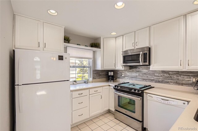 2890 W Long Cir Unit A, Littleton, CO 80120 - kitchen with appliances with stainless steel finishes, light countertops, white cabinetry, and recessed lighting