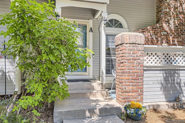 2890 W Long Cir Unit A, Littleton, CO 80120 - doorway to property featuring brick siding