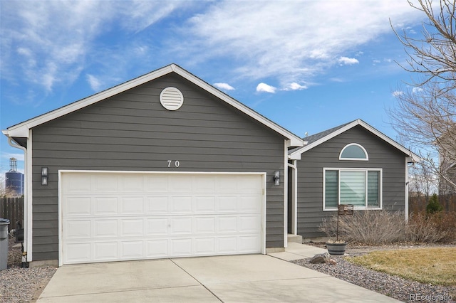 ranch-style house featuring a garage and concrete driveway