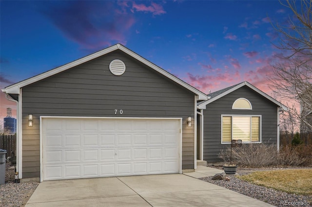 single story home featuring concrete driveway and an attached garage