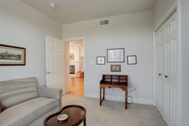 sitting room featuring light carpet