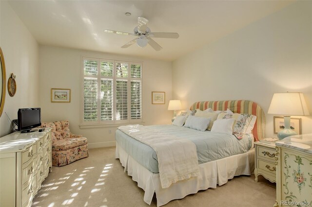 bedroom featuring ceiling fan and light colored carpet