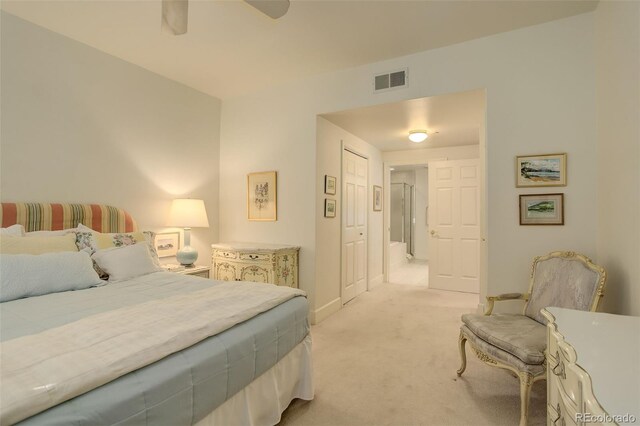 bedroom featuring ceiling fan, light colored carpet, and a closet