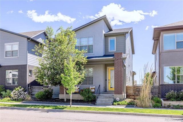 6682 Osage St, Denver, CO 80221 - view of front facade featuring stucco siding and fence