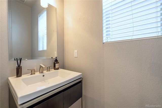 6682 Osage St, Denver, CO 80221 - bathroom with a textured wall and vanity