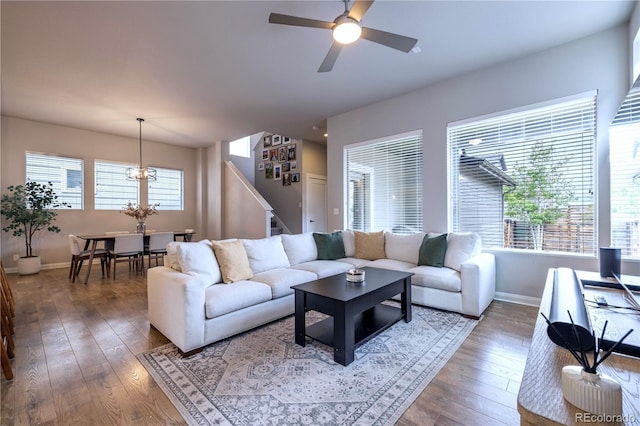 6682 Osage St, Denver, CO 80221 - living room with hardwood / wood-style floors, baseboards, a chandelier, ceiling fan, and stairs