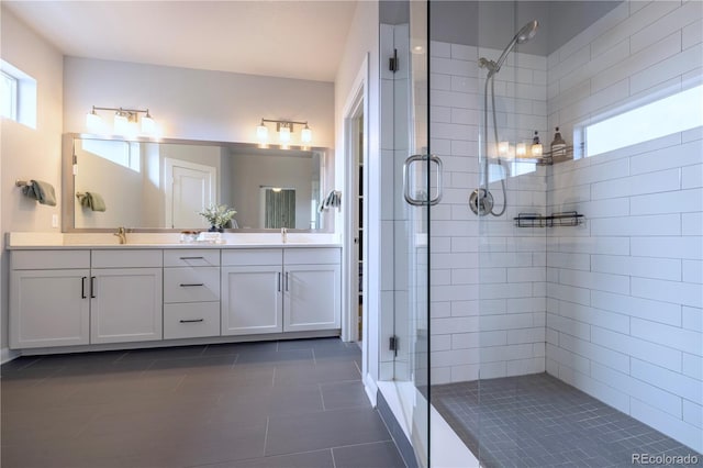 6682 Osage St, Denver, CO 80221 - bathroom with a shower stall, tile patterned flooring, and double vanity