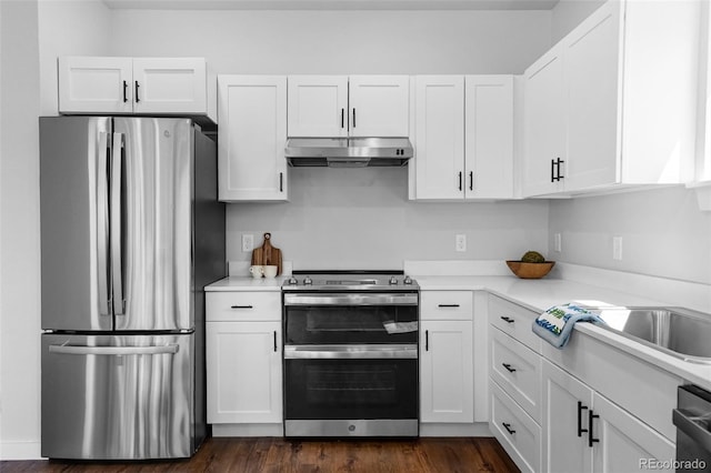 585 N Railroad St, Buena Vista, CO 81211 - kitchen with appliances with stainless steel finishes, under cabinet range hood, light countertops, white cabinets, and dark wood-style flooring