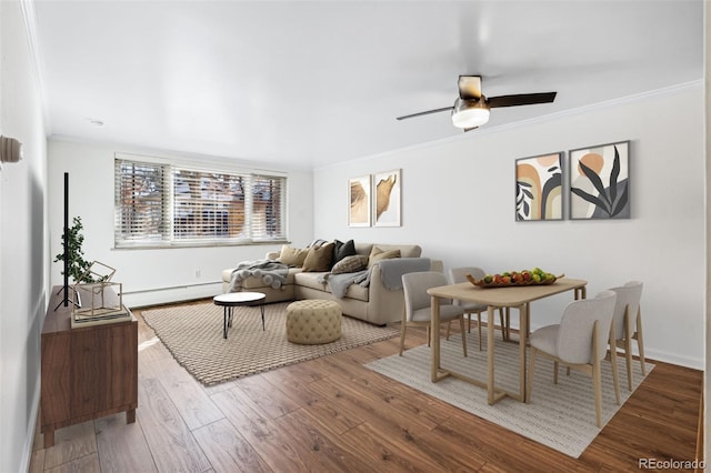 living room with hardwood / wood-style floors, crown molding, ceiling fan, and baseboard heating