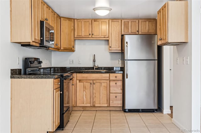 kitchen with appliances with stainless steel finishes, sink, and light tile patterned floors