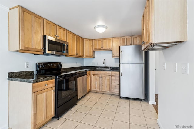 kitchen with sink, light tile patterned floors, and appliances with stainless steel finishes