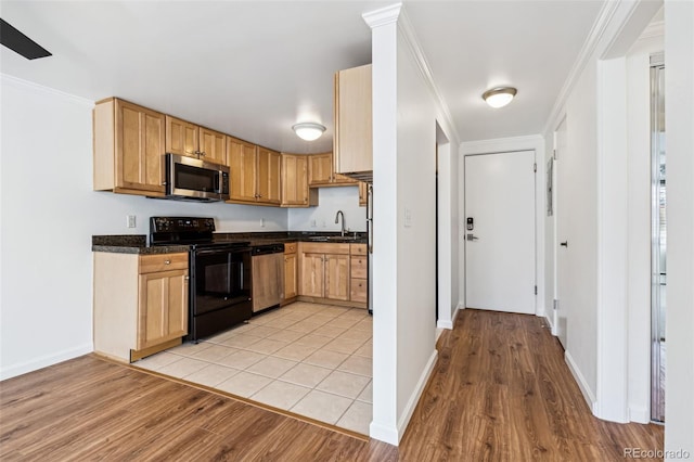 kitchen featuring sink, appliances with stainless steel finishes, ornamental molding, light hardwood / wood-style floors, and light brown cabinetry