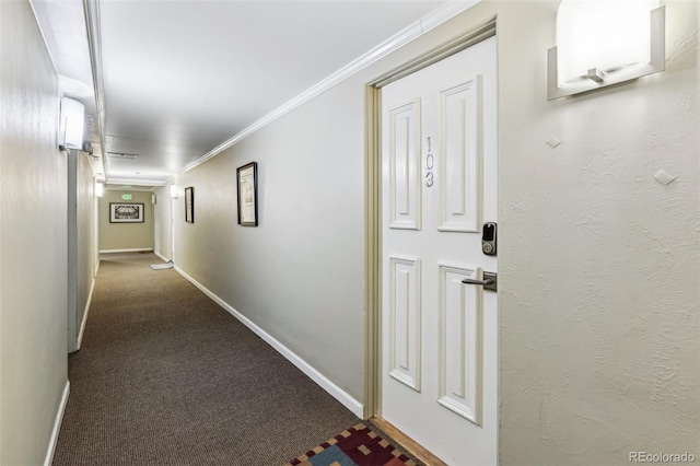 hall with carpet floors and ornamental molding