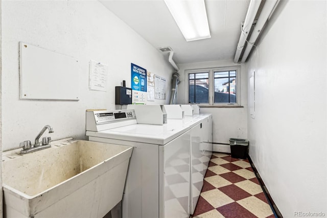 laundry room featuring washer and dryer and sink