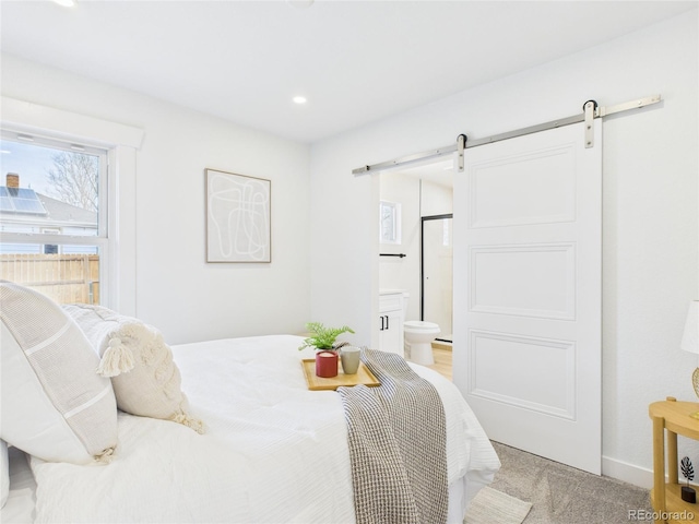 3150 S Pennsylvania St, Englewood, CO 80113 - bedroom featuring a barn door, light colored carpet, ensuite bathroom, and recessed lighting