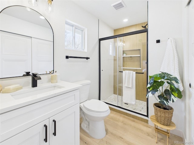 3150 S Pennsylvania St, Englewood, CO 80113 - bathroom featuring vanity, wood finished floors, a stall shower, and recessed lighting