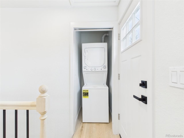 3150 S Pennsylvania St, Englewood, CO 80113 - washroom with stacked washer and clothes dryer and light wood finished floors