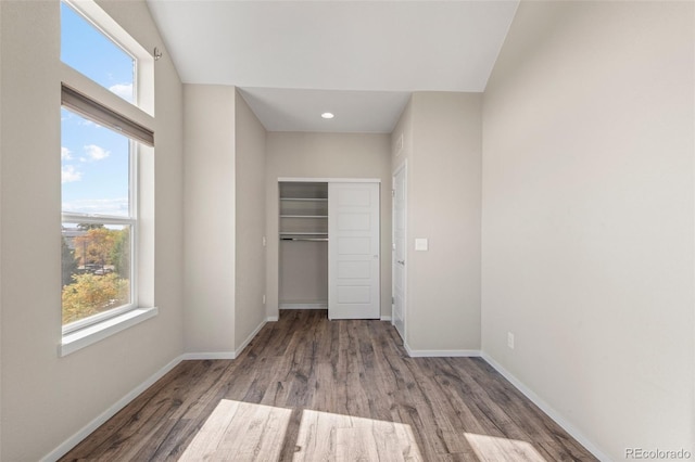 unfurnished bedroom with a closet and light hardwood / wood-style flooring