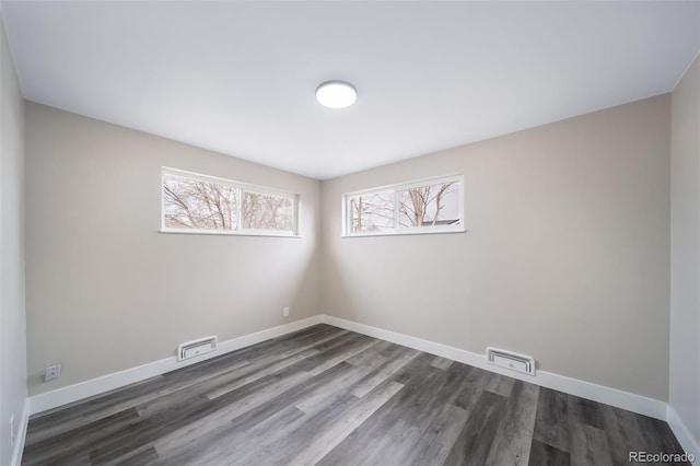 spare room featuring dark hardwood / wood-style flooring