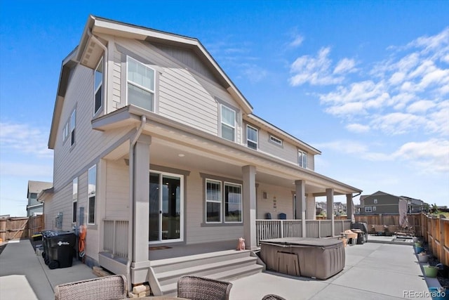 14601 Hudson St, Thornton, CO 80602 - view of front of house featuring a hot tub, a patio area, and a fenced backyard