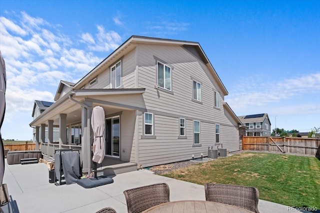 14601 Hudson St, Thornton, CO 80602 - rear view of house with a patio, a fenced backyard, and a hot tub