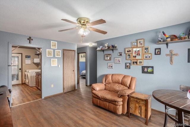 sitting room featuring ceiling fan, separate washer and dryer, and dark hardwood / wood-style flooring