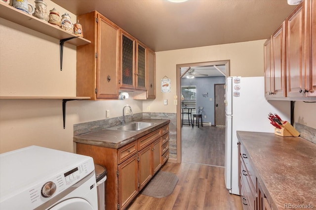 kitchen featuring sink, white fridge, ceiling fan, washer / clothes dryer, and light hardwood / wood-style floors