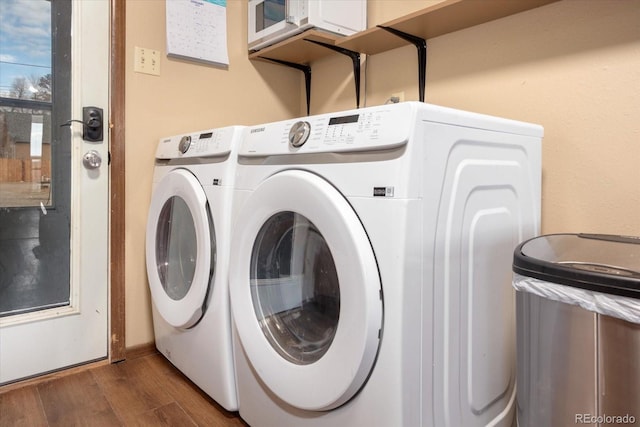 laundry room featuring dark hardwood / wood-style floors and washer and dryer