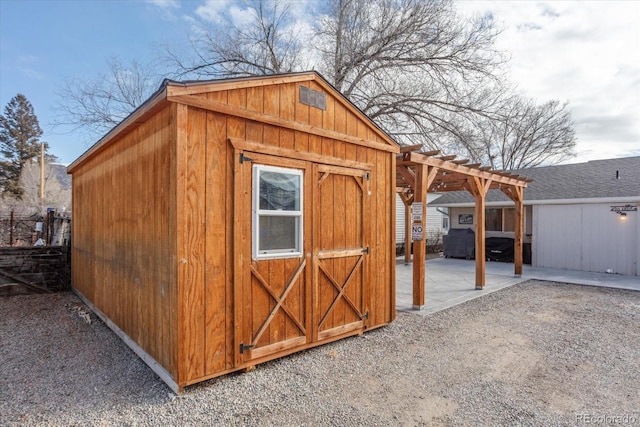 view of outbuilding featuring a pergola