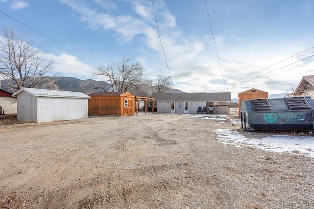 exterior space with a mountain view and an outdoor structure