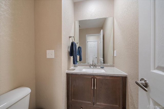 10610 Winterflower Way, Parker, CO 80134 - half bathroom with a textured wall, toilet, and vanity