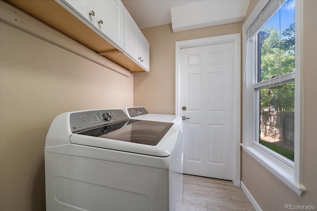 10610 Winterflower Way, Parker, CO 80134 - laundry room featuring cabinet space, washer and clothes dryer, healthy amount of natural light, and light wood-style flooring