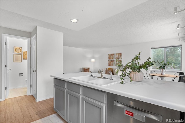 1741 W 131st Ct, Denver, CO 80234 - kitchen with gray cabinets, dishwasher, light countertops, a textured ceiling, and recessed lighting