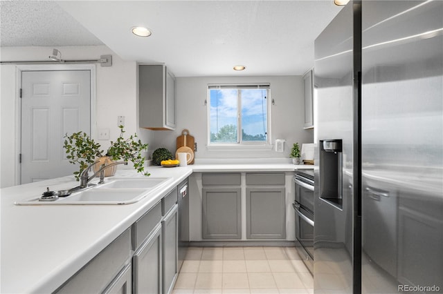 1741 W 131st Ct, Denver, CO 80234 - kitchen featuring appliances with stainless steel finishes, gray cabinets, light tile patterned flooring, light countertops, and recessed lighting