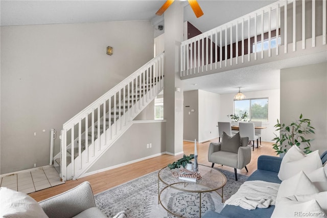 1741 W 131st Ct, Denver, CO 80234 - living area with stairs, wood finished floors, high vaulted ceiling, and ceiling fan