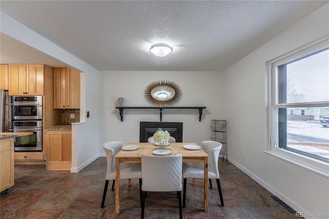 dining area featuring a textured ceiling